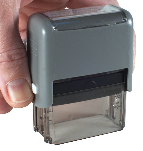 Pressing down on a ClassiX stamp and releasing the white locking buttons on either side