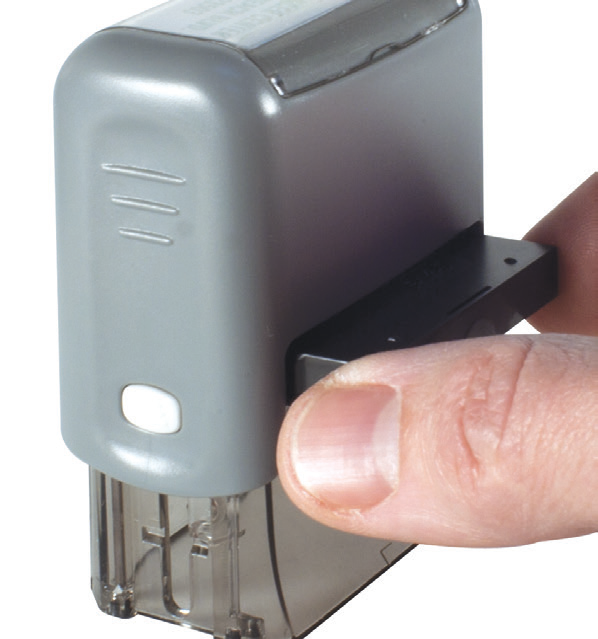 Sliding the ink pad out of a ClassiX stamp, inked side facing down
