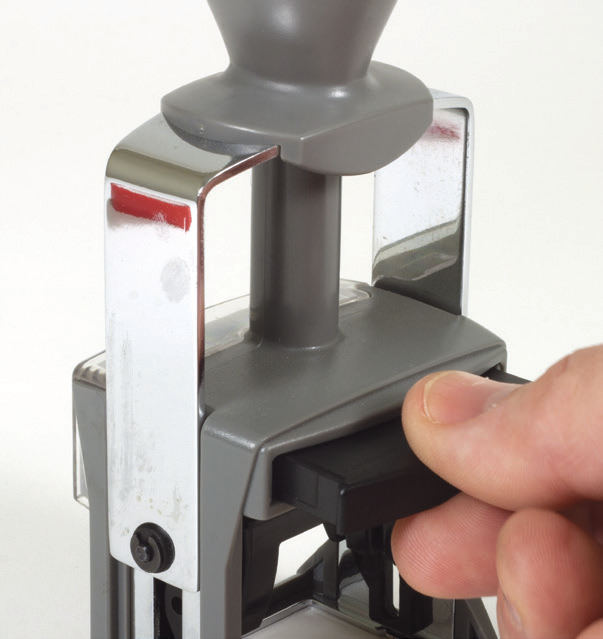 Sliding the ink pad out of a ClassiX stamp with a front locking button