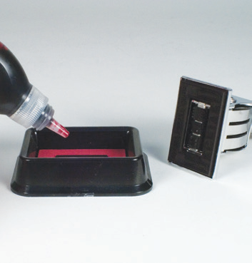 Adding refill ink to the base of a two-colour die-plate Xstamper stamp