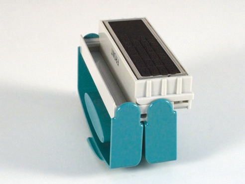 Sliding the impression cartridge out of the handle of an Xstamper pocket stamp