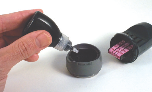 Removing the base of an Xstamper vX date stamp and adding refill ink to the cap pad