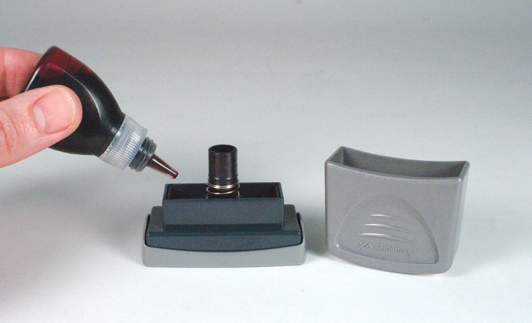 Removing the handle of an Xstamper vX message stamp and adding refill ink to the openings
